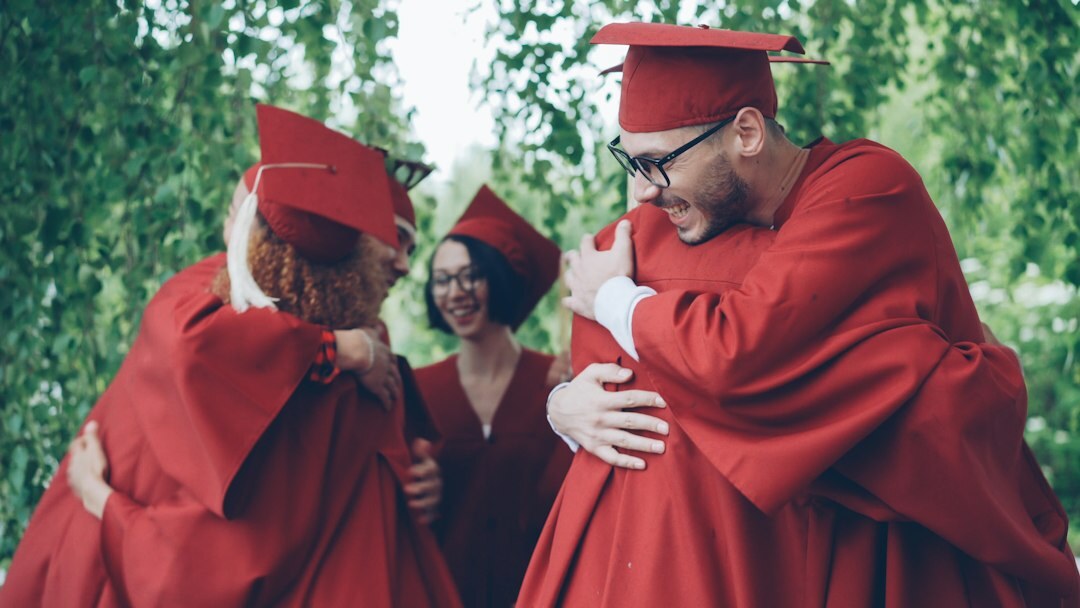 Diverse group of graduates celebrating together outdoors