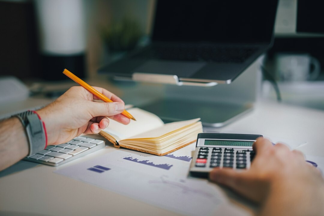 person tracking expenses on notebook